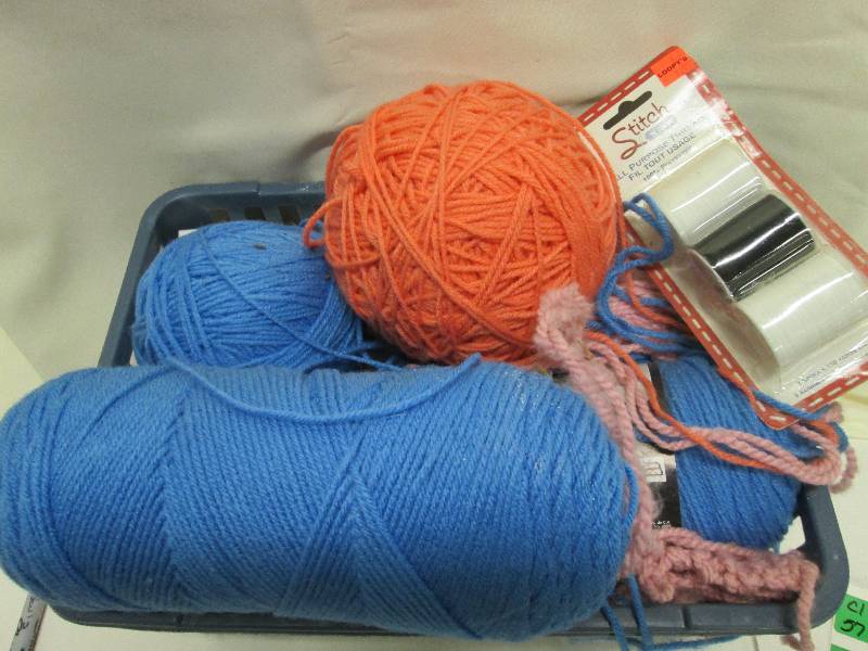 Pink blue yarn in basket plud blac...