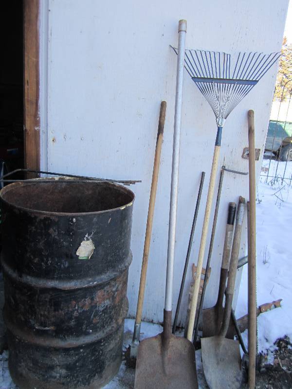 metal barrel full of assorted tools...