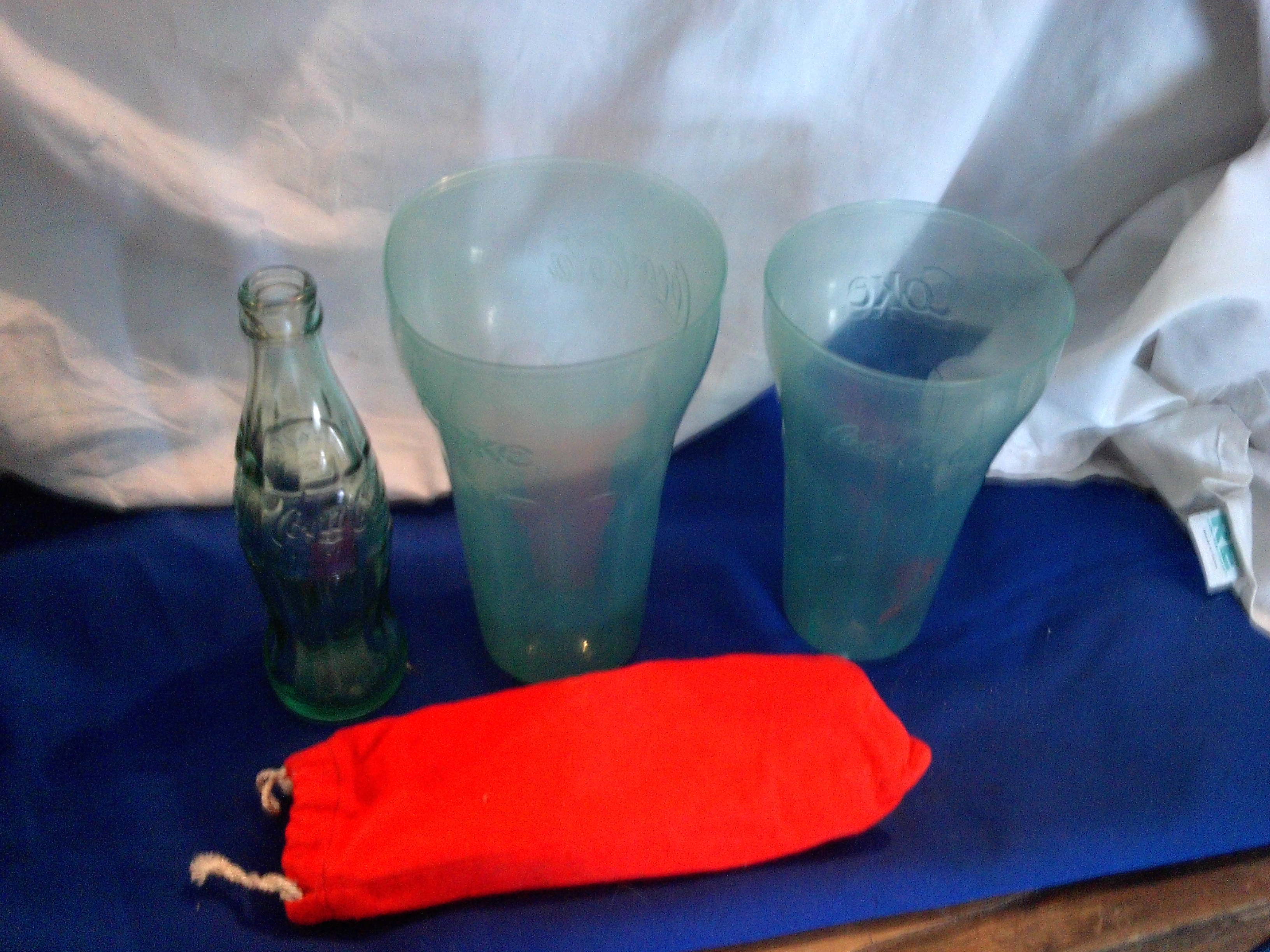 coca cola plastic glasses and 1 glass bottle