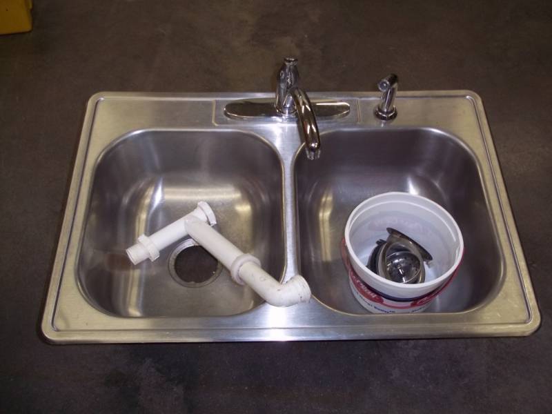 lot 31 image: Kitchen Sink  with Faucet and plumbing hardware.