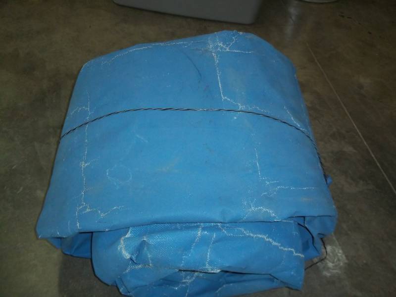lot 57 image: Tarp may have some holes good for woodpile