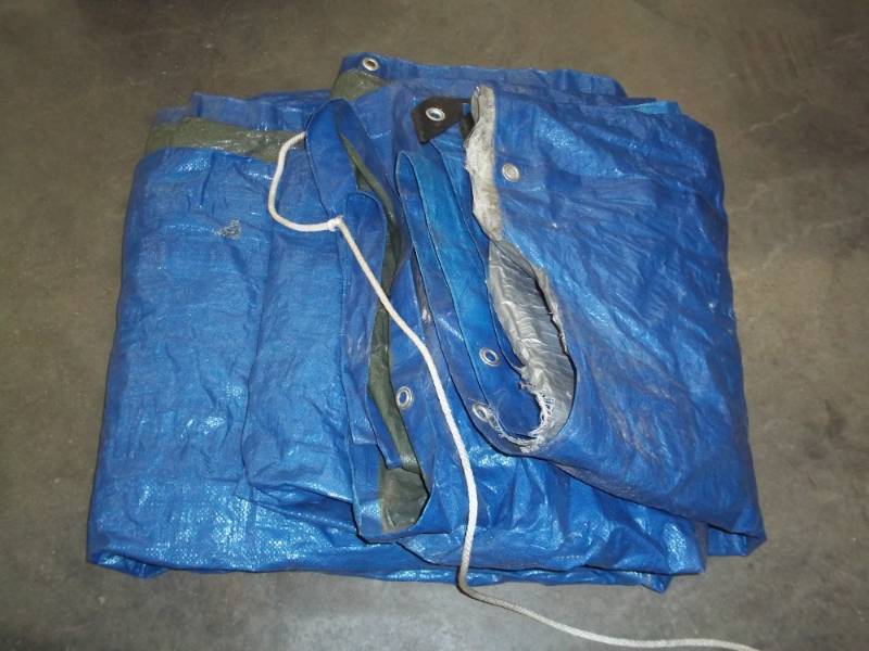 lot 59 image: Tarp may have some holes good for woodpile