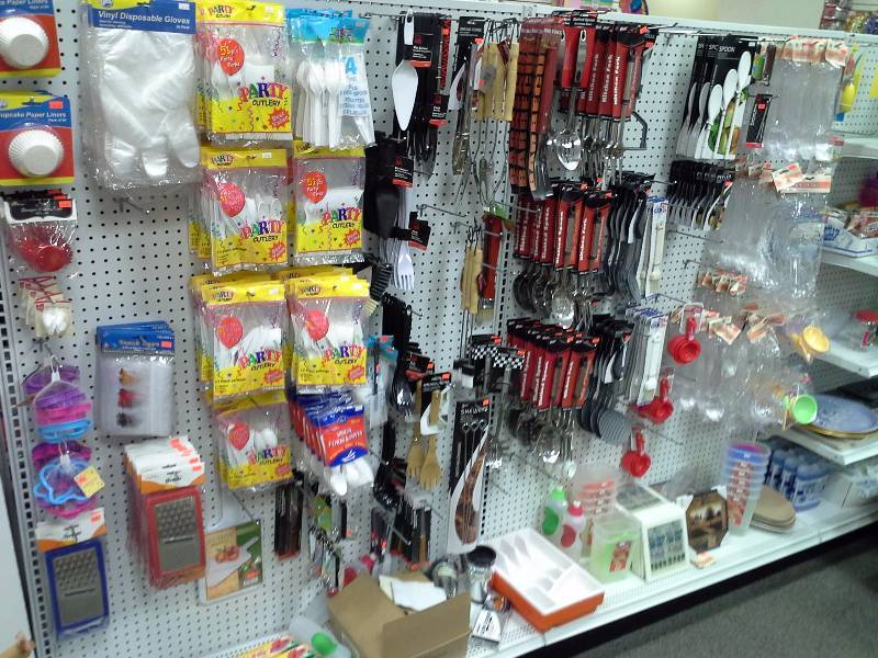 Assortment of kitchen utensils, plastic cutlery, and other kitchen items