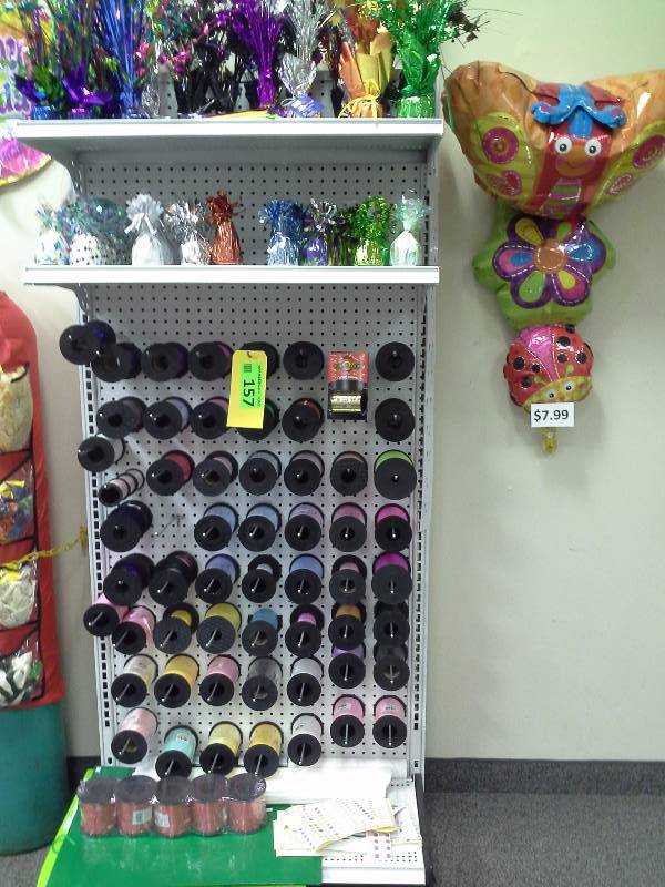 Assortment of ribbon, balloon weights, and shelving included