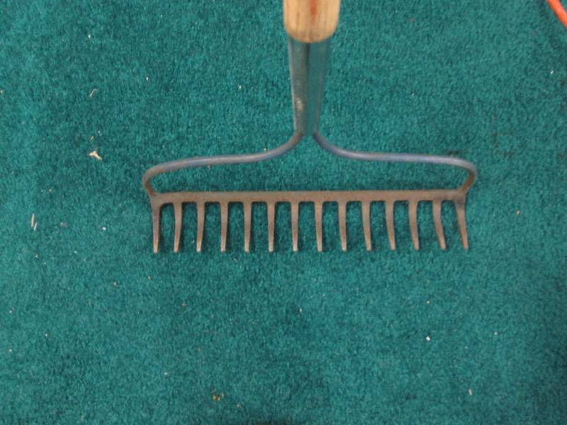 Garden rake with good wooden handle...