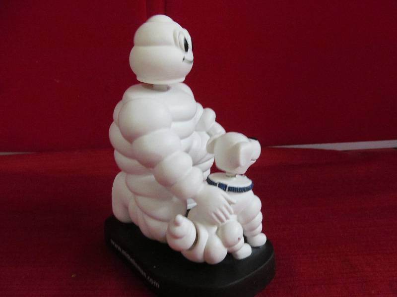 Michelin man and dog bobble head