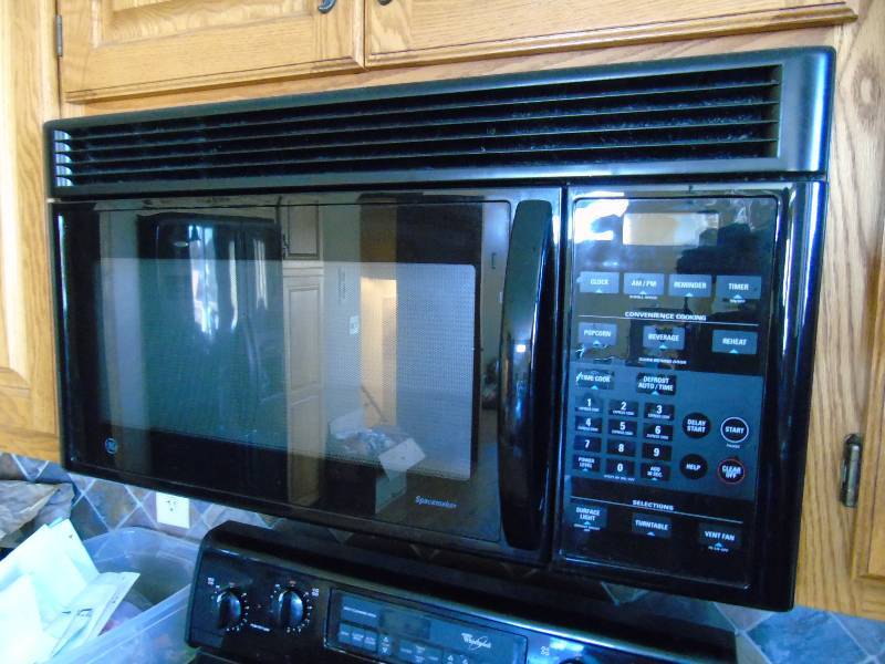 lot 12 image: GE Microwave (Model # JVM1440BD 003)
