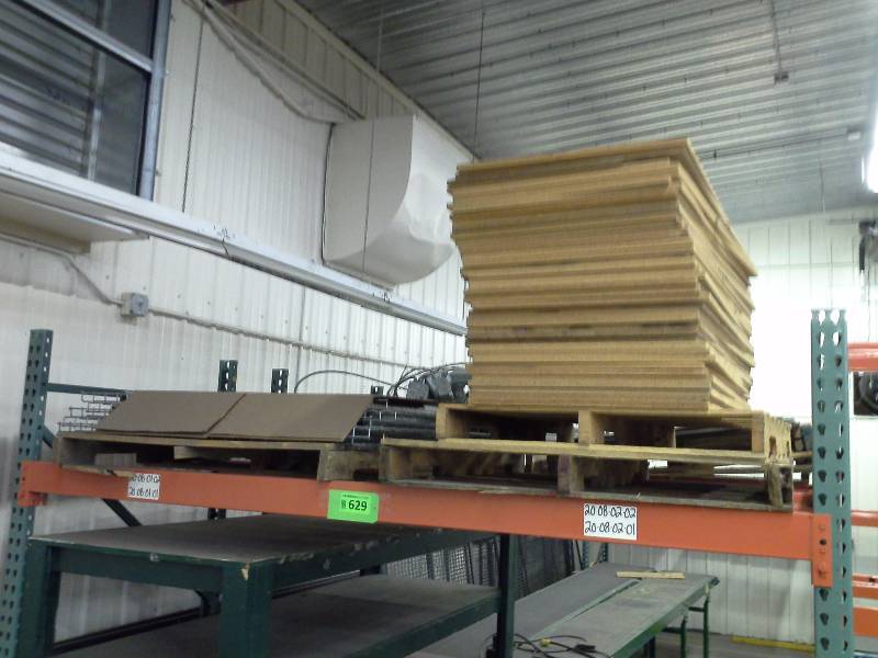 Stack of particleboard shelves and small quantity of wire decking