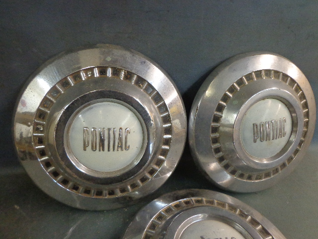 lot 10 image: Metal Pontiac Hubcaps