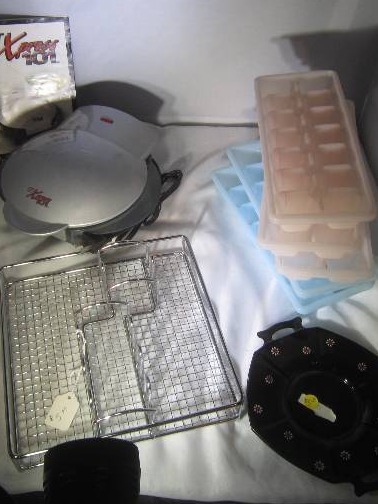 lot 853 image: Lot of Kitchen Items - Ice cube trays, Silverware Holder, GT Express 101, Antique Black Glass Plate