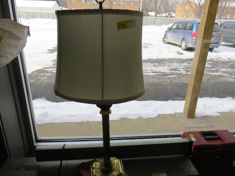 brass colored table lamp with shade