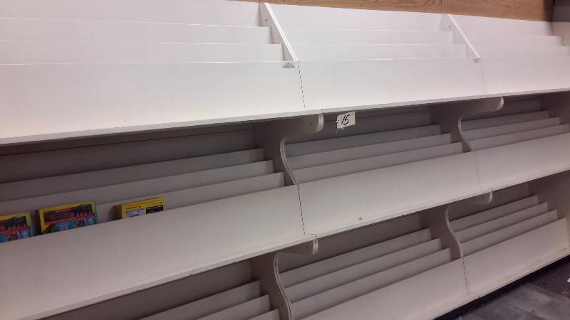 Wall Magazine Rack..  12ft long.. Wood.. Each section looks to be 4 ft. wide.. Not sure how it comes apart, but you are required to do this.. Right by the door.