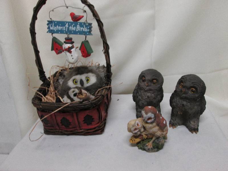 Plush owls nesting in basket with w...