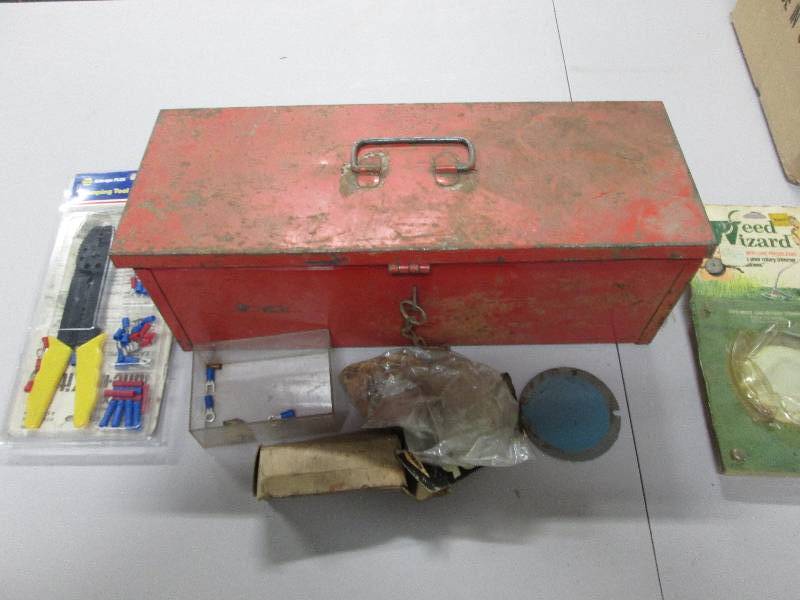 Red metal tool box containing crim...