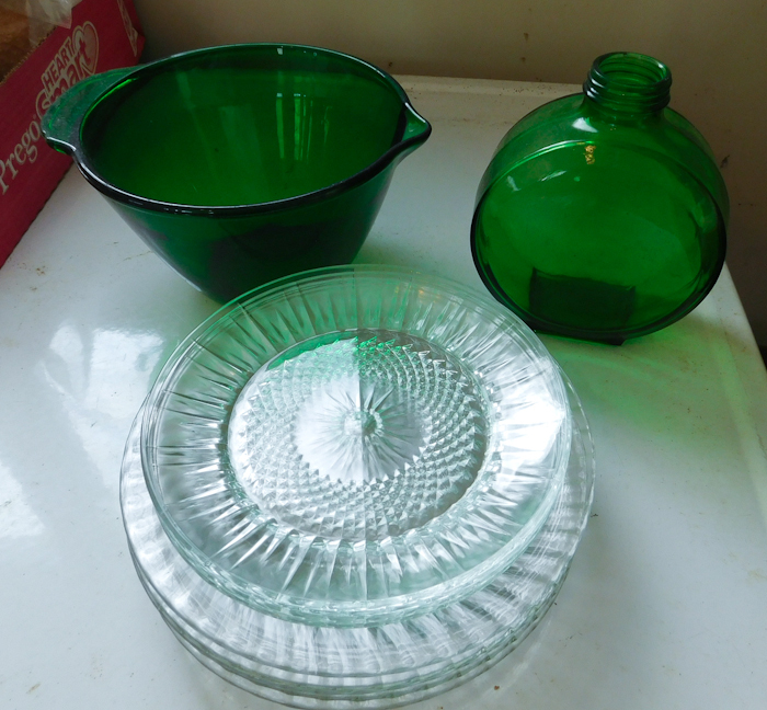 lot 65 image: green bottle, green pouring mixing bowl and clear glass plates