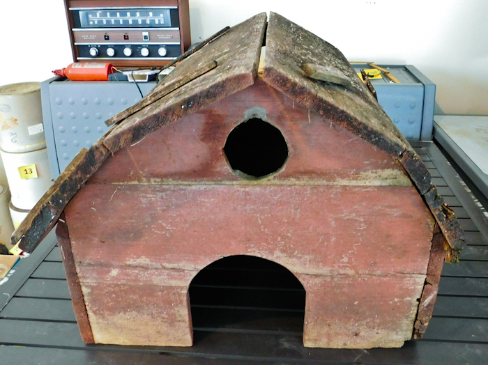 lot 89 image: Vintage homemade red barn with wooden roof.