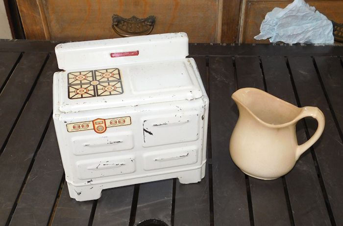 lot 143 image: vintage metal toy stove nice decals and small pitcher