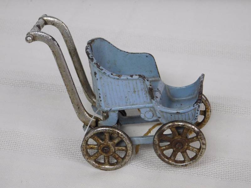lot 171 image: Antique Cast Iron toy baby buggy