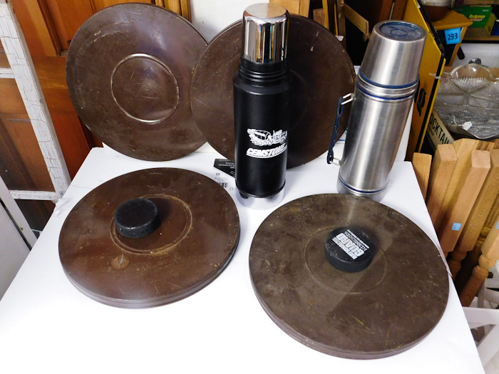 lot 255 image: two metal thermoses 4 vintage film cans and 2 hockey pucks