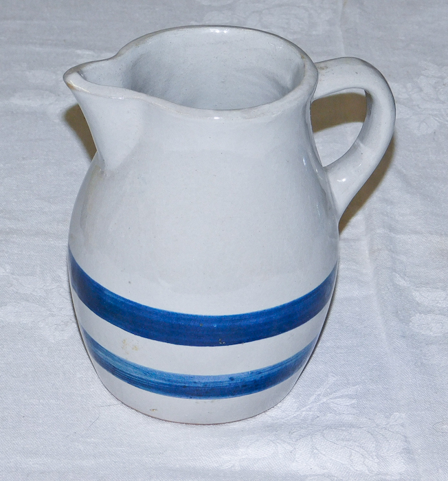 lot 31 image: white stoneware pitcher with two blue stripes