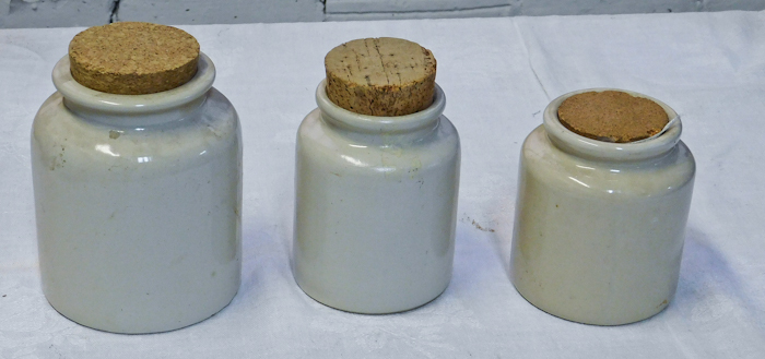 lot 35 image: three unmarked small crocks with cork stoppers