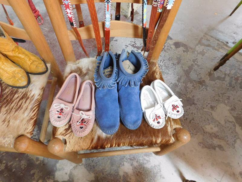 lot 132 image: Three pair of moccasins two are minnetonka moccasins