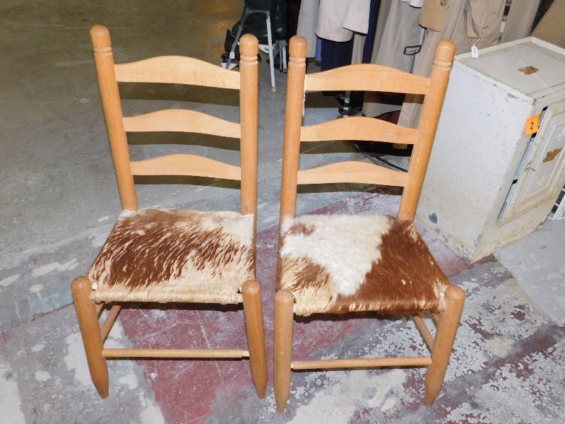 lot 142 image: two vintage ladder back chairs with horse hair leather seats.