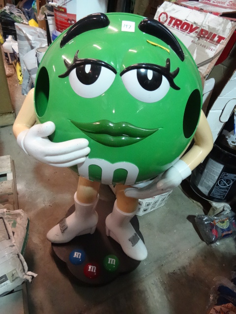 lot 197 image: USED M&M Display Figurine and Storage Green, Female, approx 3 ft Tall On Wheels