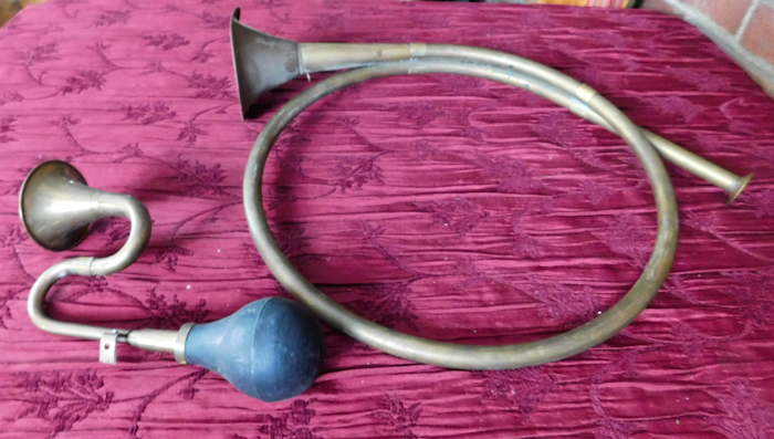 lot 189 image: two brass horn one has a squeeze bulb