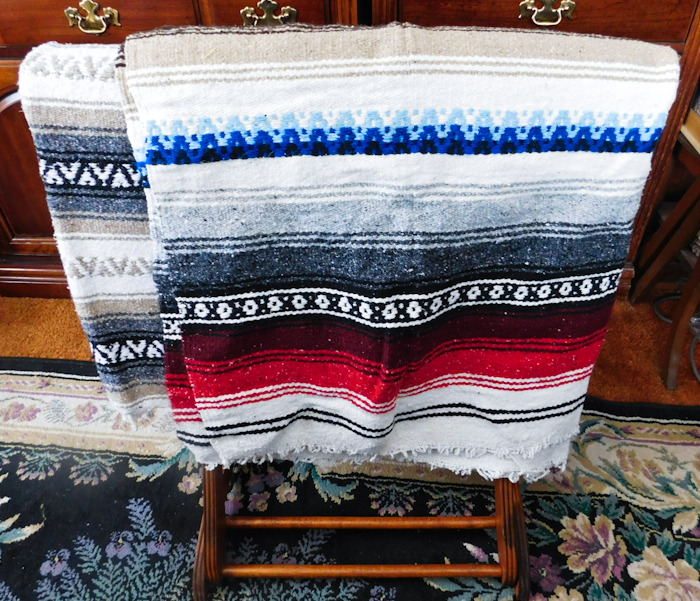 lot 18 image: blanket rack and two Mexican style blankets