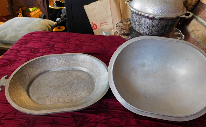 lot 101 image: Two covered hammered aluminum dutch ovens and a glass cake plate