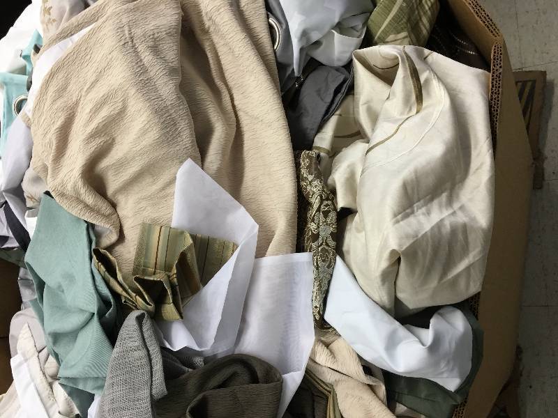 lot 155 image: Large gaylord of new sheets,couch covers and curtains random sizes and colors