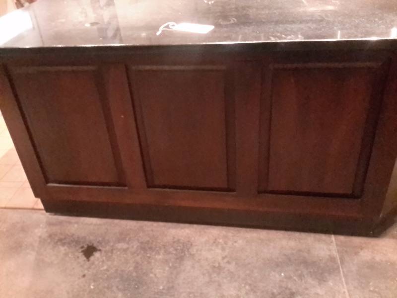 lot 47 image: Service Counter with Corian Type Counter  top.. Elbow style.  Overall length.. 83in x 32in w countertop x 36in h.. Nice dark wood faceframe.