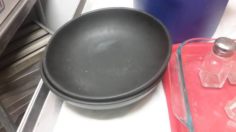 lot 79 image: A PAIL full of salt and pepper shakers (see examples).. 15 wicker plate baskets, 11 x 15 glass cake pan, Plastic tray