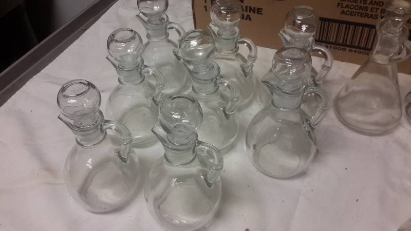 lot 102 image: 12 Cruets.. 3 different styles.. See pictures and info on box