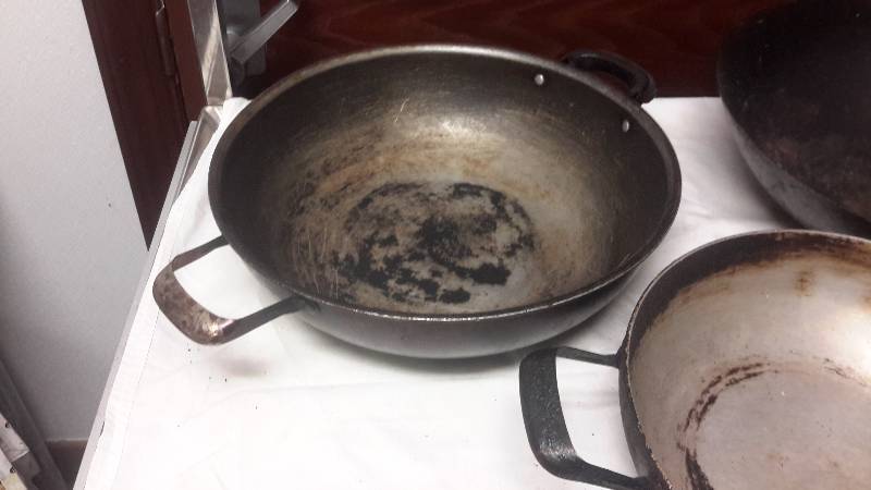 lot 130 image: 3 pans.. 1, wok 1, 2 handle woksauce pan 1 pan with bad handle.