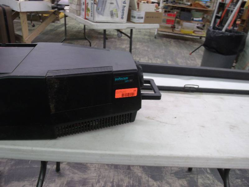older computer projection with wall mount screen