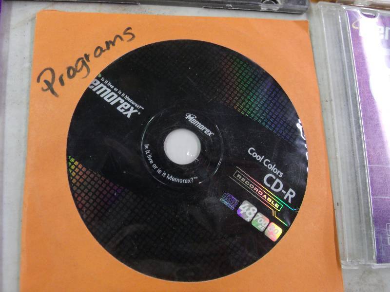 assortment of cds, dvds, games, hard drive