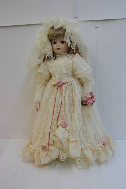 lot 8 image: Lovely bride porcelain collectible doll.